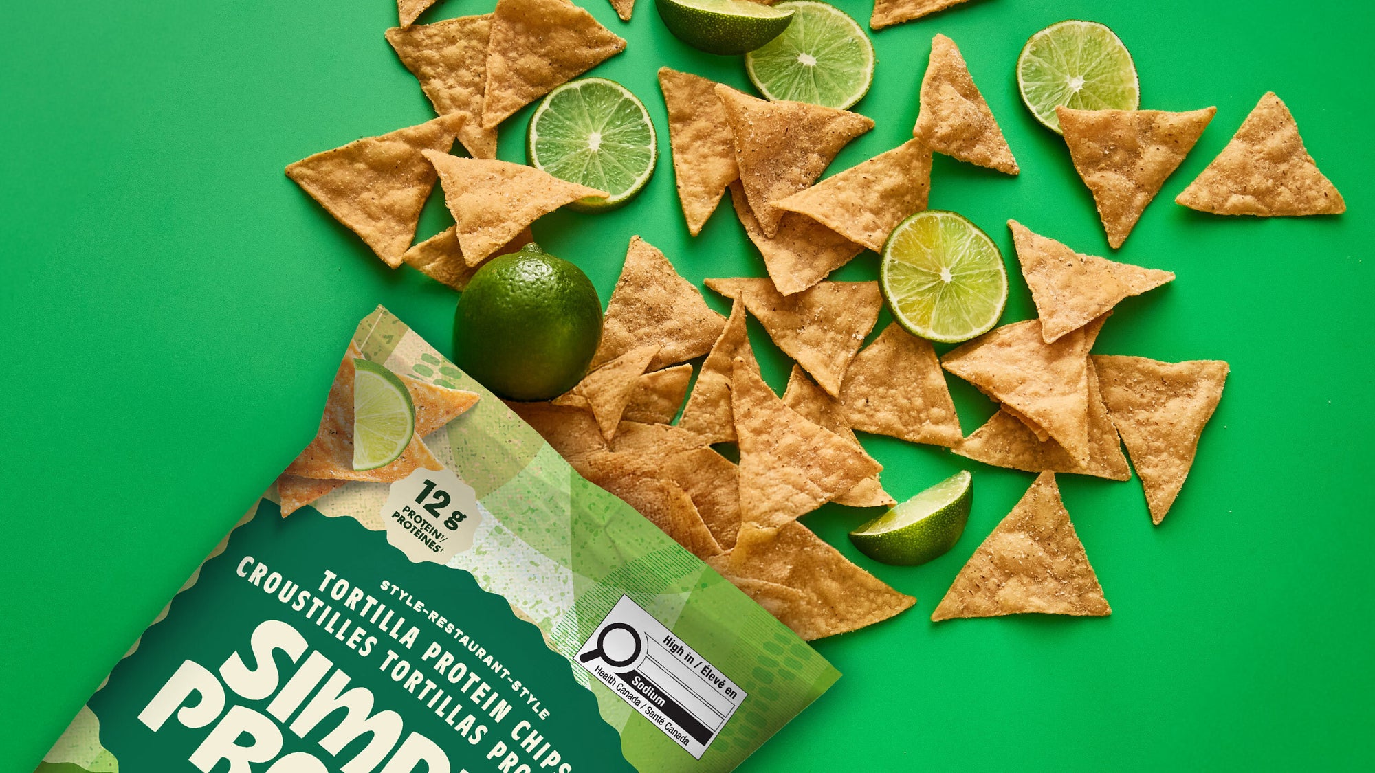 Tortilla chips with limes on a green background, featuring a Simple Truth packaging.
